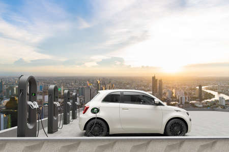 Compact electric car charging in the station of rooftop with city background, renderの写真素材