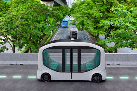 Autonomous electric shuttle bus self driving across city green road, Smart vehicle conceptの写真素材