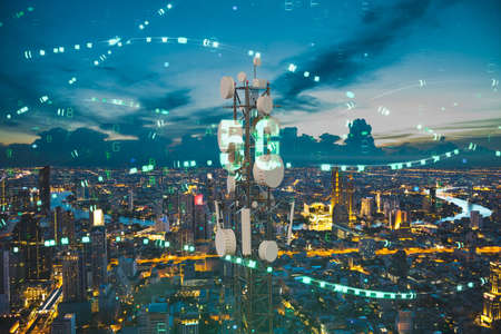 Telecommunication tower with 5G cellular network antenna on night city background, Digital big data conceptの写真素材