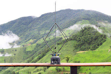 Retro military direction finder antenna on mountain view backgroundの写真素材