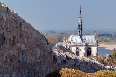 Old chapel with stone wall in the foreground