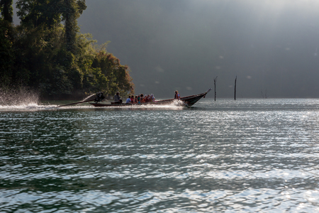 THAILAND - March 18, 2017: Thai long-tail boat with tourists on Cheow Lan lake, Thailandのeditorial素材
