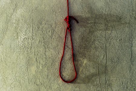 scary and death concept with red rope noose for death on cement wallの写真素材