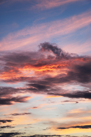 Beautiful red sky with clouds during the sunset. Sun set to Baltic sea. Texture and background of blue sky in summer.の写真素材