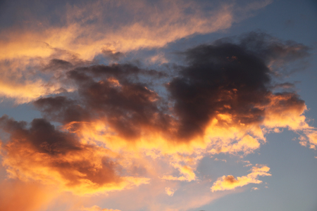 Beautiful red sky with clouds during the sunset. Sun set to Baltic sea. Texture and background of blue sky in summer.の写真素材