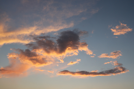 Beautiful red sky with clouds during the sunset. Sun set to Baltic sea. Texture and background of blue sky in summer.の写真素材