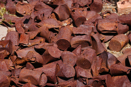 Old, rusty, weathered cans in an abandoned old town.の写真素材