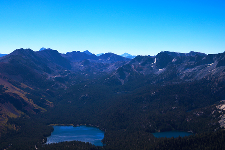 View of the lake surrounded by mountains on a sunny day.の写真素材