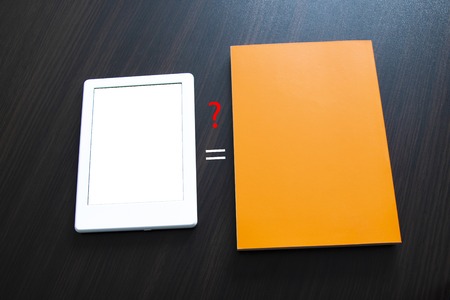 Choose between e-book and paper book. Concepts of self-educationの写真素材