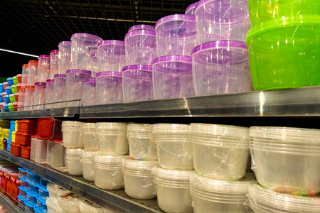 A set of different colors and sizes of containers in the storeの写真素材
