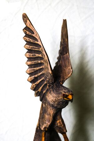 Beautiful wooden figure of an eagle on a white backgroundの写真素材