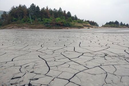 Dry cracked earth. Soil during the drought season. Background close up. The texture of the desertの写真素材