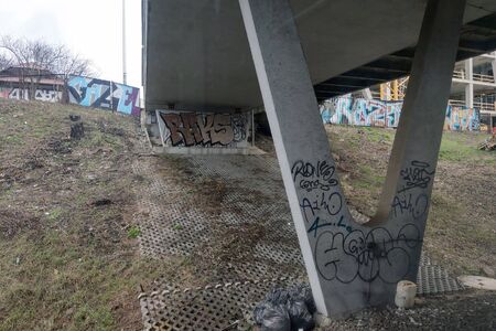 Painted graffiti old bridge, abandoned place, a lot of garbage, the problem with the environmentの写真素材