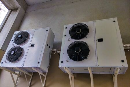 View of large air conditioners mounted on the wall of the building. Air conditioning systemの写真素材