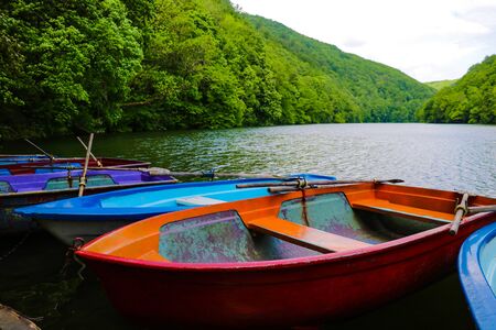 Small pleasure boats on the lake surrounded by greeneryの写真素材