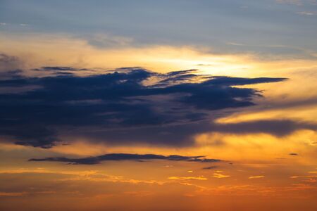 Sunset with sun rays, sky with clouds and sunの写真素材