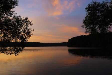 Sunset river sky clouds landscape. River sunset horizon view. Sunset river landscape. River sunset viewの写真素材