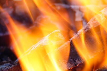 Glowing embers in hot red color, abstract background. The hot embers of burning wood log fire....