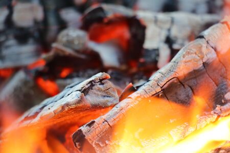 Decaying coals for cooking and a backgroundの写真素材
