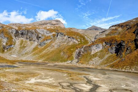 Beautiful alpine mountains, Austria. Fresh clean air, nature background. On the tops of the mountains lies snow all year round. Out of focus. Picturesque places to relax and climb the mountainsの写真素材