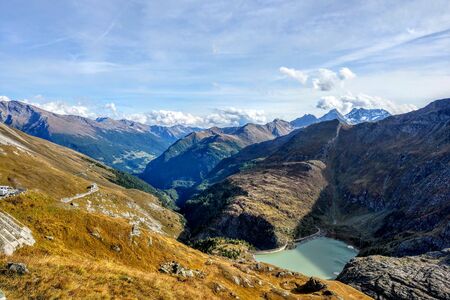 Beautiful alpine mountains. Fresh clean air. Selective focus. Picturesque places to relax and climb the mountains. Mountain lake surrounded by mountains, cold clear waterの写真素材
