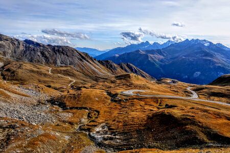 Beautiful alpine mountains, Austria. Fresh clean air, nature background. On the tops of the mountains lies snow all year round. Out of focus. Mountain scenic roadの写真素材