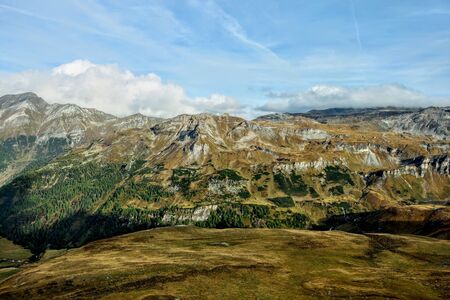 Beautiful alpine mountains, Austria. Fresh clean air, nature background. On the tops of the mountains lies snow all year round. Out of focus. Picturesque places to relax and climb the mountainsの写真素材