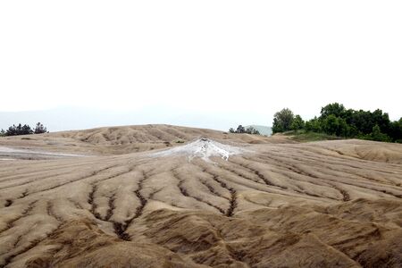 Muddy volcanoes. View of the muddy volcanoes with their unusual geology and cracked texture of the dry mud. Romania, out of focusの写真素材