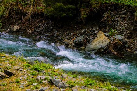 A small mountain cold stream drains quickly from the mountainsの写真素材