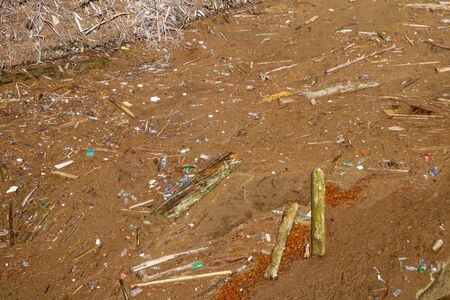 The view from the height of the lake with garbage on the shore. Ecology. Environmental pollutionの写真素材