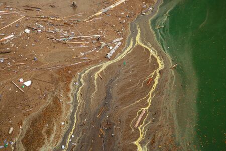 The view from the height of the lake with garbage on the shore. Ecology. Environmental pollutionの写真素材