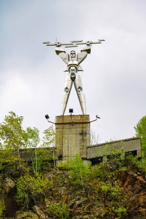 Romania - May 12, 2019: Energia statue by Constantin Popovici, representing Prometheus with lightning in his hands, symbolizing electricity, at the edge of Vidraru lakeのeditorial素材