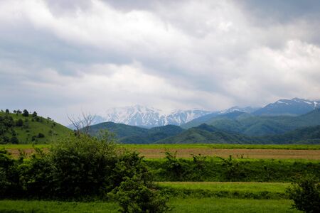 View of the mountain and dark sky during the rain, out of focusの写真素材