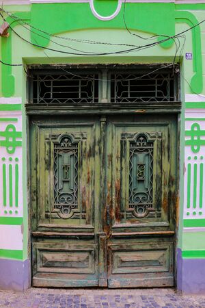 Sibiu, Romania, May 15, 2019: Traditional, colorful, decaying wooden courtyard doors of old townhouses in the centerのeditorial素材
