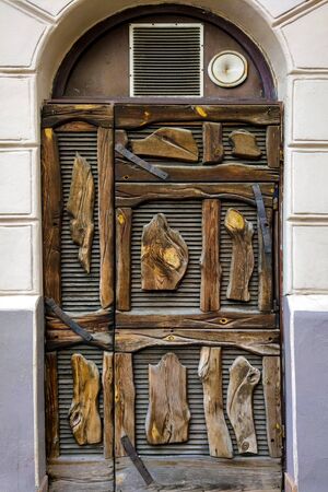 Antique door and window frame using well crafted tree piecesの写真素材