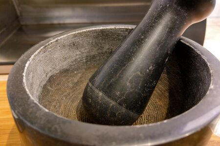 A close-up on mortar and pestle is a tool that pharmacists use to grind medicine and make medicine, which consists of mortar and pestleの写真素材