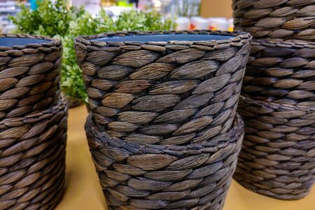 View of a beautiful planter under the flowers on the wicker tableの写真素材
