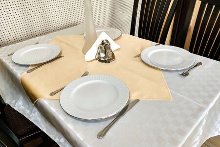 Empty dishes, knifes and forks on wood tableの写真素材