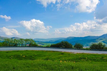 View of the mountain road, blue sky, mountains on the horizonの写真素材