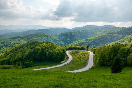 View of the mountain road, blue sky, mountains on the horizonの写真素材