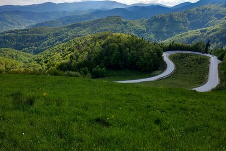 View of the mountain road, blue sky, mountains on the horizon. Selective focusの写真素材