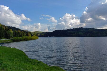 Blue lake idill under cloudline skyの写真素材