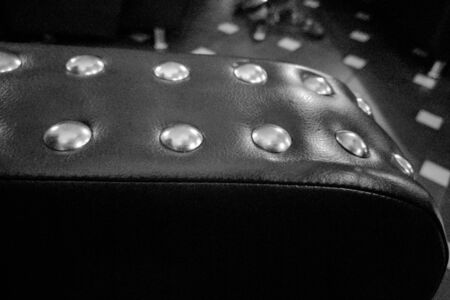 Closeup texture of vintage black leather sofa for backgroundの写真素材