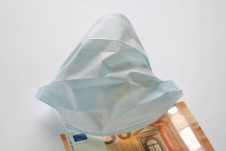 Medical mask on euro banknotes. Coronavirus. There is a place for copyspaceの写真素材