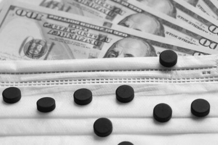 Medical mask on dollar bills. Healthcare concept. Epidemic, virus