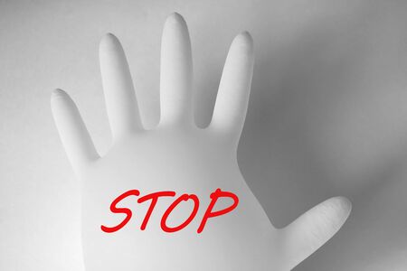 Medical glove on a white background with the text STOP. Pandemic, coronavirusの写真素材