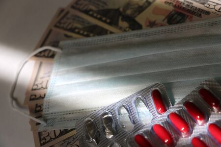 COVID-19 coronavirus in USA. 50 dollar money bill with coronavirus . COVID-19 affects global stock...