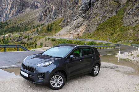 Udine Region, Italy - September 15, 2019: Kia Sportage 4 stands on the side of the road. Background with Dolomites Mountainsのeditorial素材