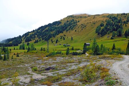 Picturesque landscape of foggy morning in mountain village in Dolomites Alpsの写真素材