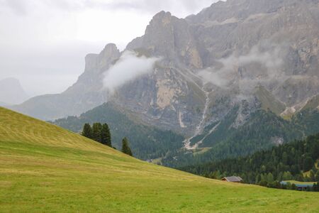 Picturesque landscape of foggy morning in mountain village in Dolomites Alps, selective focusの写真素材
